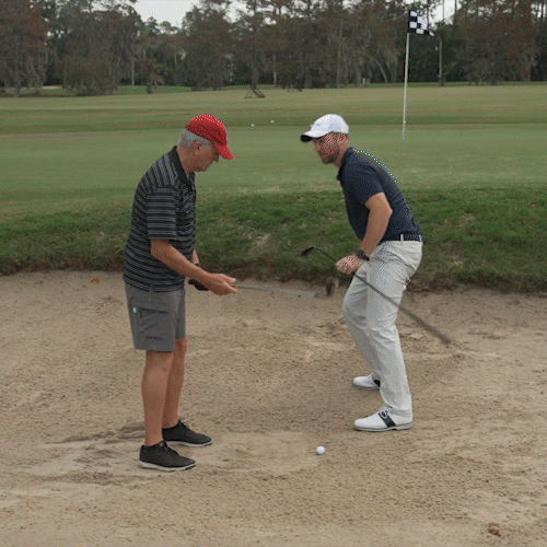 Golfer confidently hitting from bunker